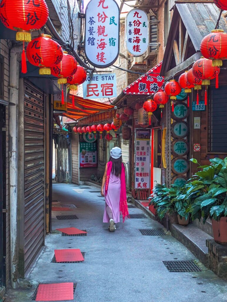 girl taking a walk in food heaven jiufen, taiwan