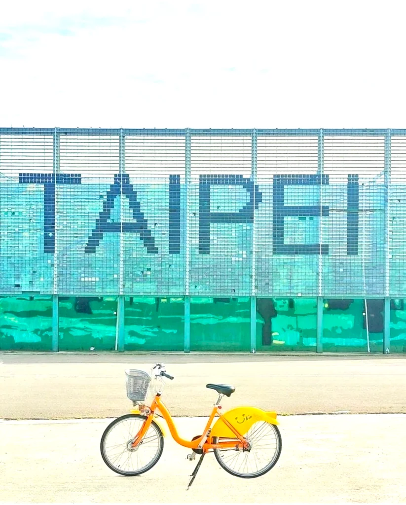 A yellow youbike in Taipei, with a backdrop of Taipei background. U Bike is the best app for biking in Taiwan