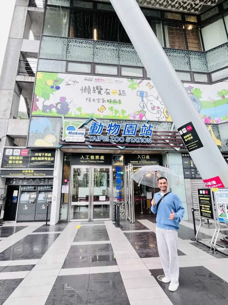 man standing outside Maokong Gondola Station in Taipei