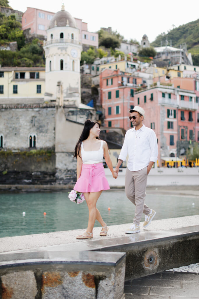 Jade guiding Deeshen during a photoshoot amidst the picturesque landscapes of Cinque Terre, Italy.