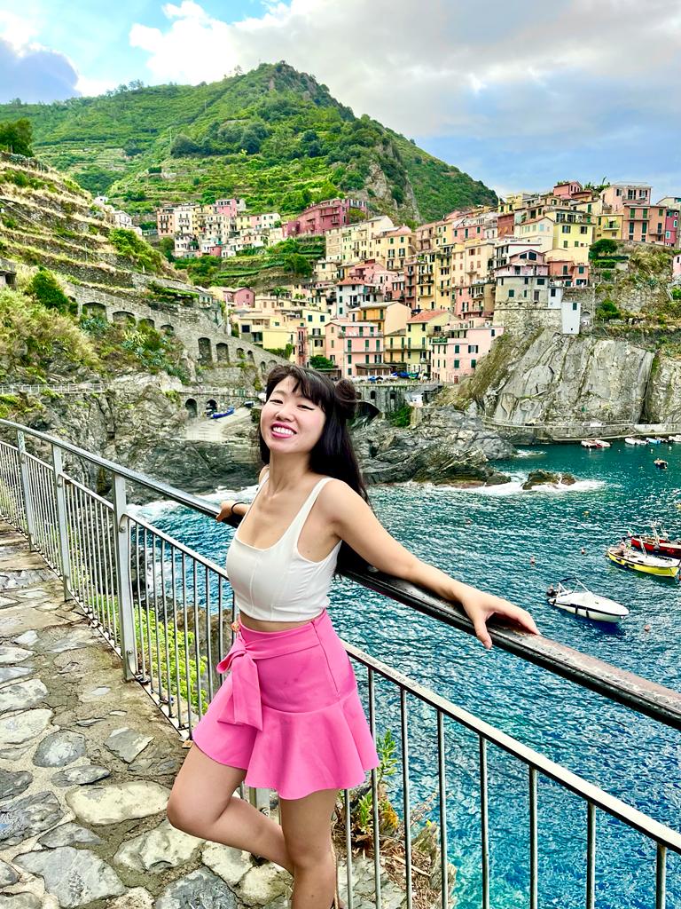 Jade posing gracefully in front of the picturesque backdrop of Manarola, Cinque Terre, Italy