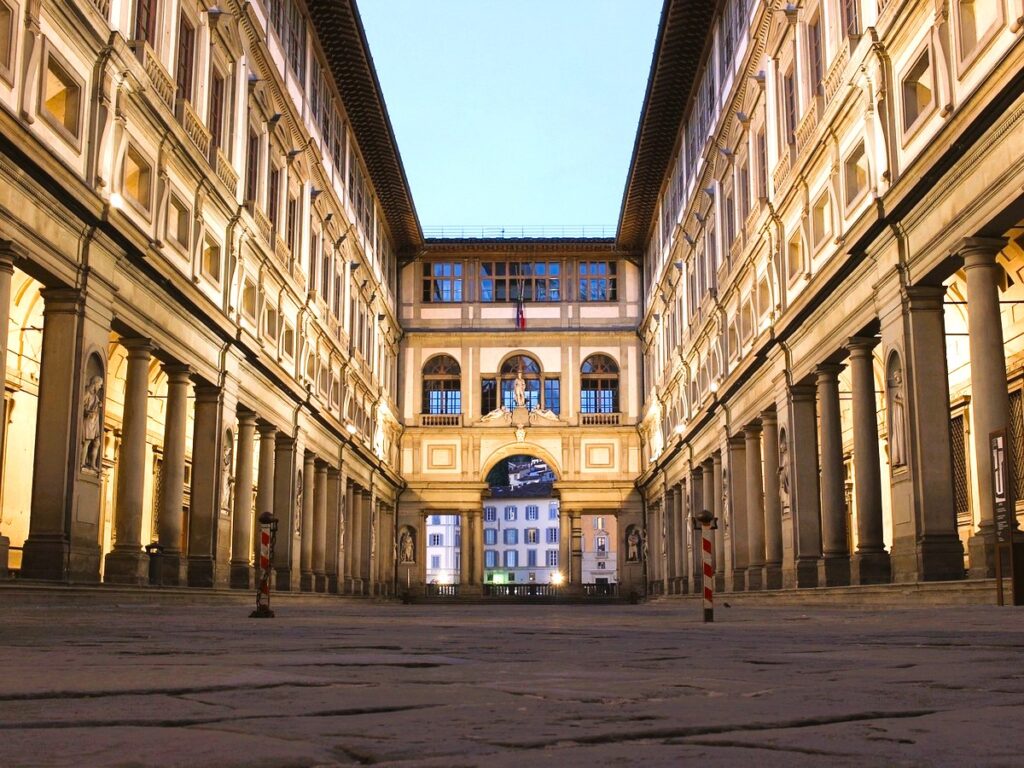 Uffizi Gallery's grand court yard lighted up. Uffizi Museum is the best art museum in Florence Italy, and has a strict Uffizi Gallery dress code to maintan a dignified atmosphere. 